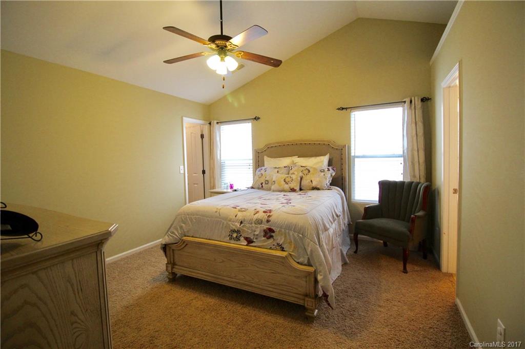 1022 Mearn Road Charlotte, NC 28216 - Photo 10 of 15 a bedroom with a bed and a chandelier