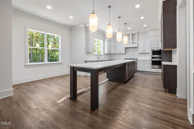 a kitchen with a sink window and cabinets