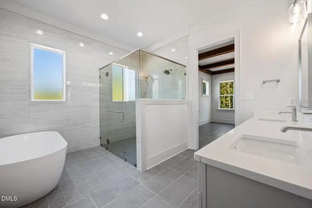 a view of wooden house with a small yard and wooden fence