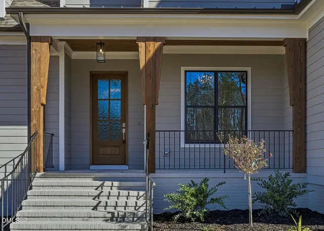 a large kitchen with kitchen island a stove a sink a refrigerator and white cabinets with wooden floor