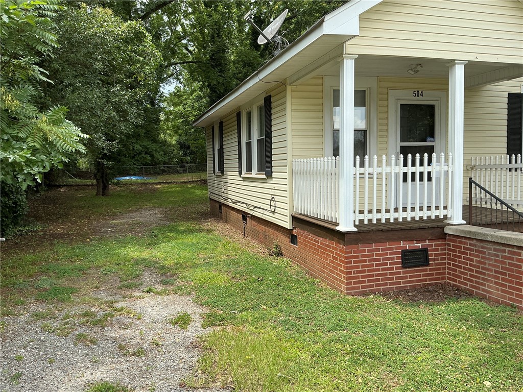 504 Caughlin Avenue Anderson, SC 29624 - Photo 13 of 15 A charming front porch welcomes you, featuring classic picket railings and sturdy columns.