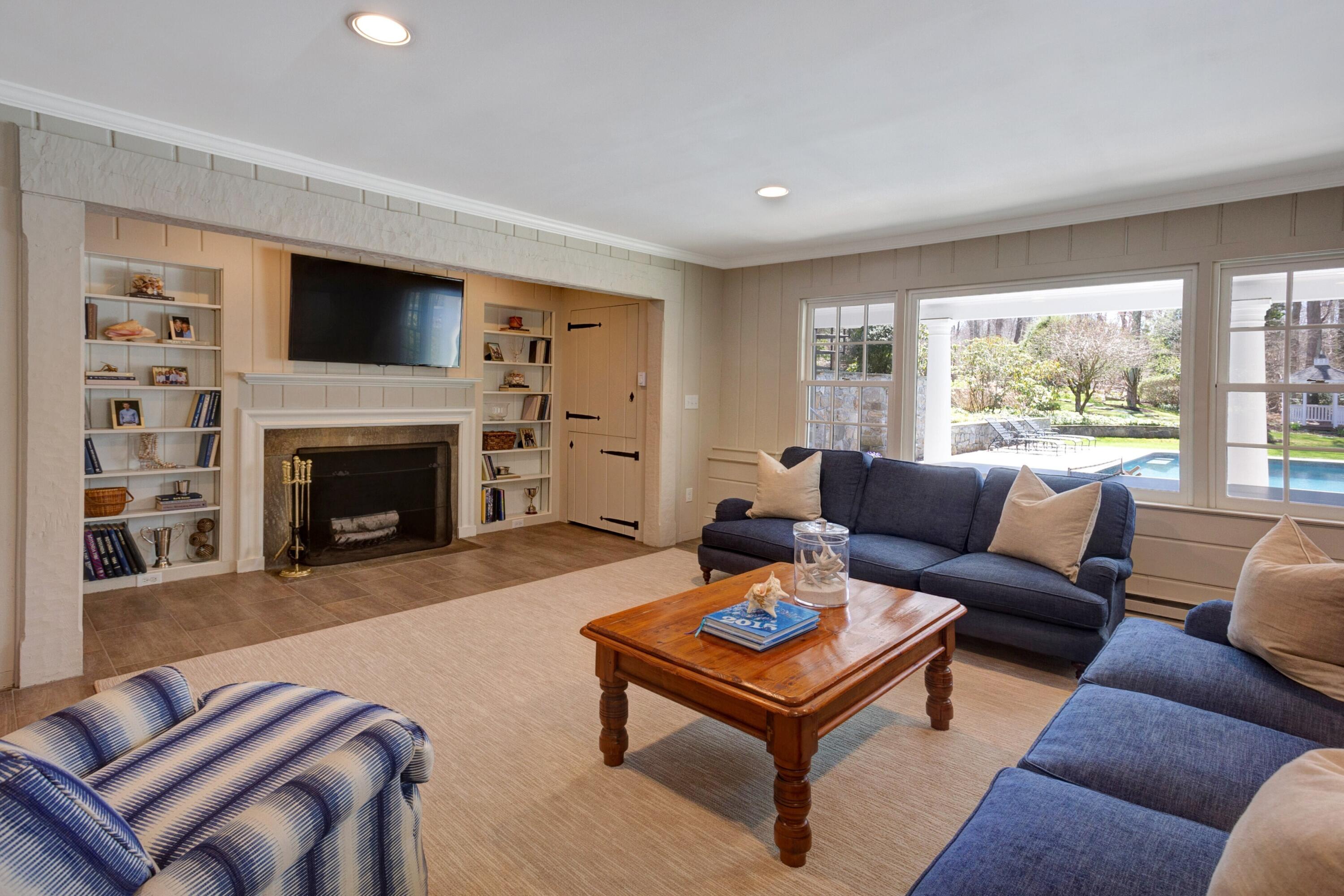 16 Half Mile Road Darien, CT 06820 - Photo 21 of 59 a living room with furniture a large window and a fireplace
