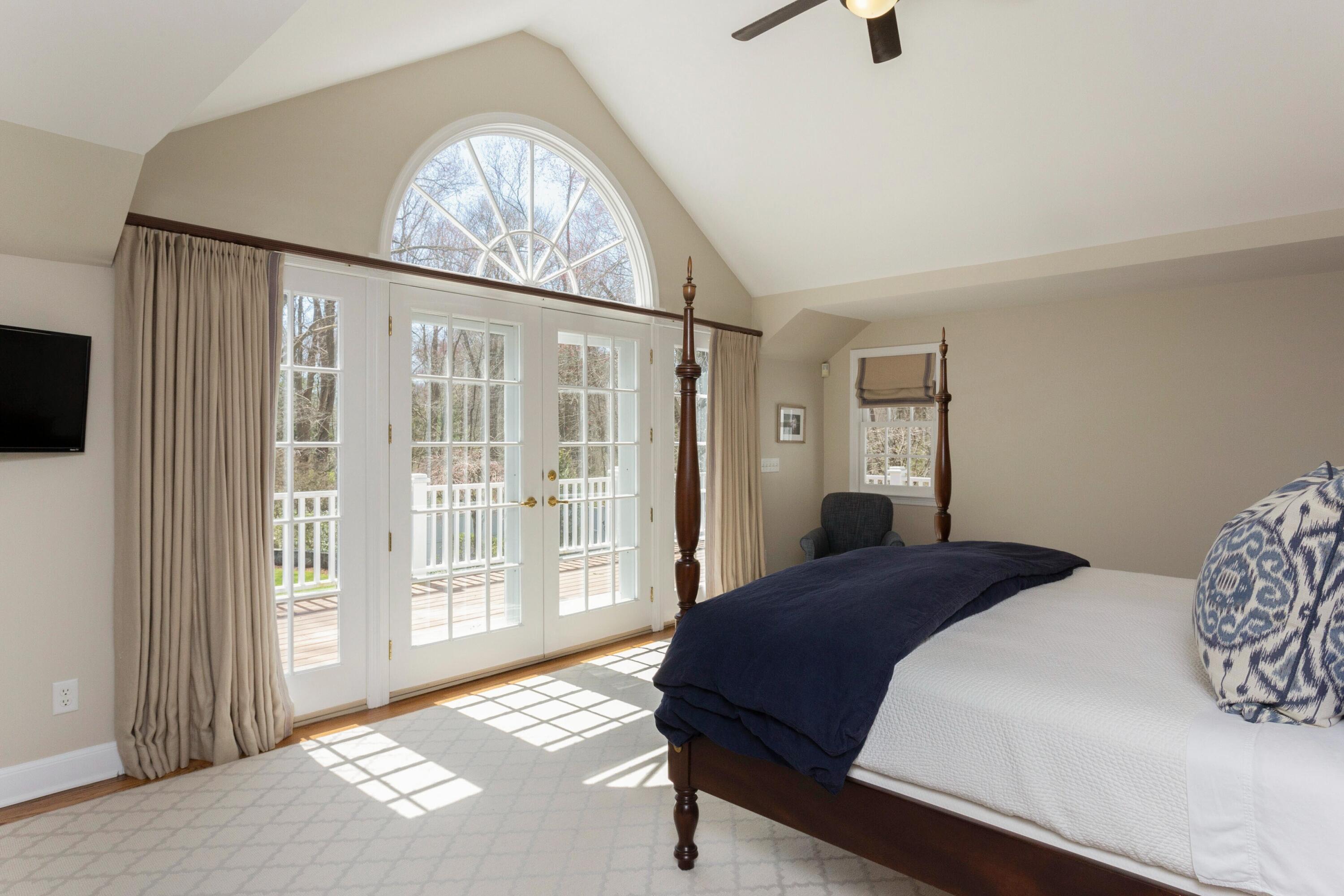 16 Half Mile Road Darien, CT 06820 - Photo 25 of 59 a bedroom with a large bed and a large window