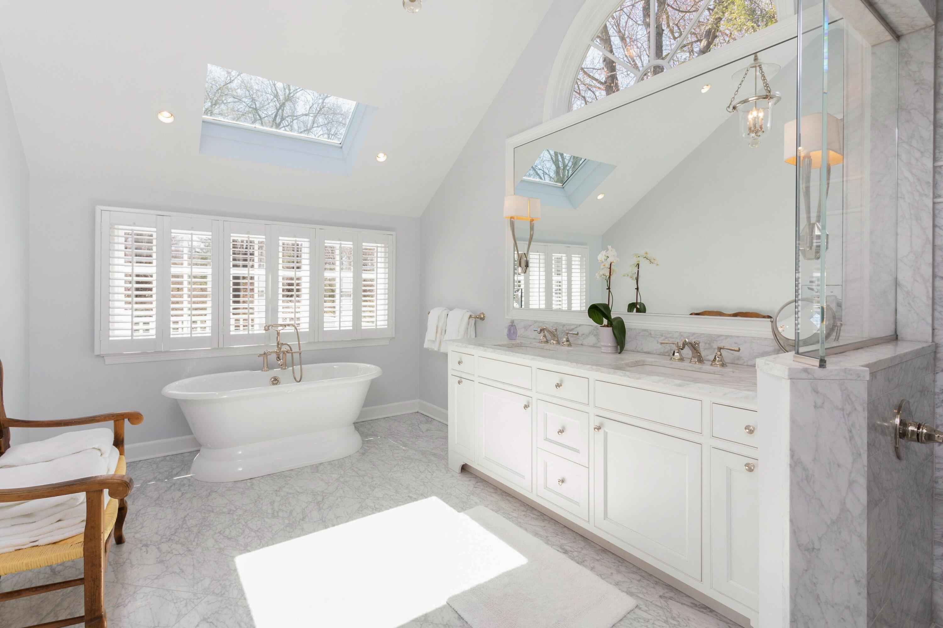 16 Half Mile Road Darien, CT 06820 - Photo 26 of 59 a spacious bathroom with a double vanity sink a mirror and a bathtub