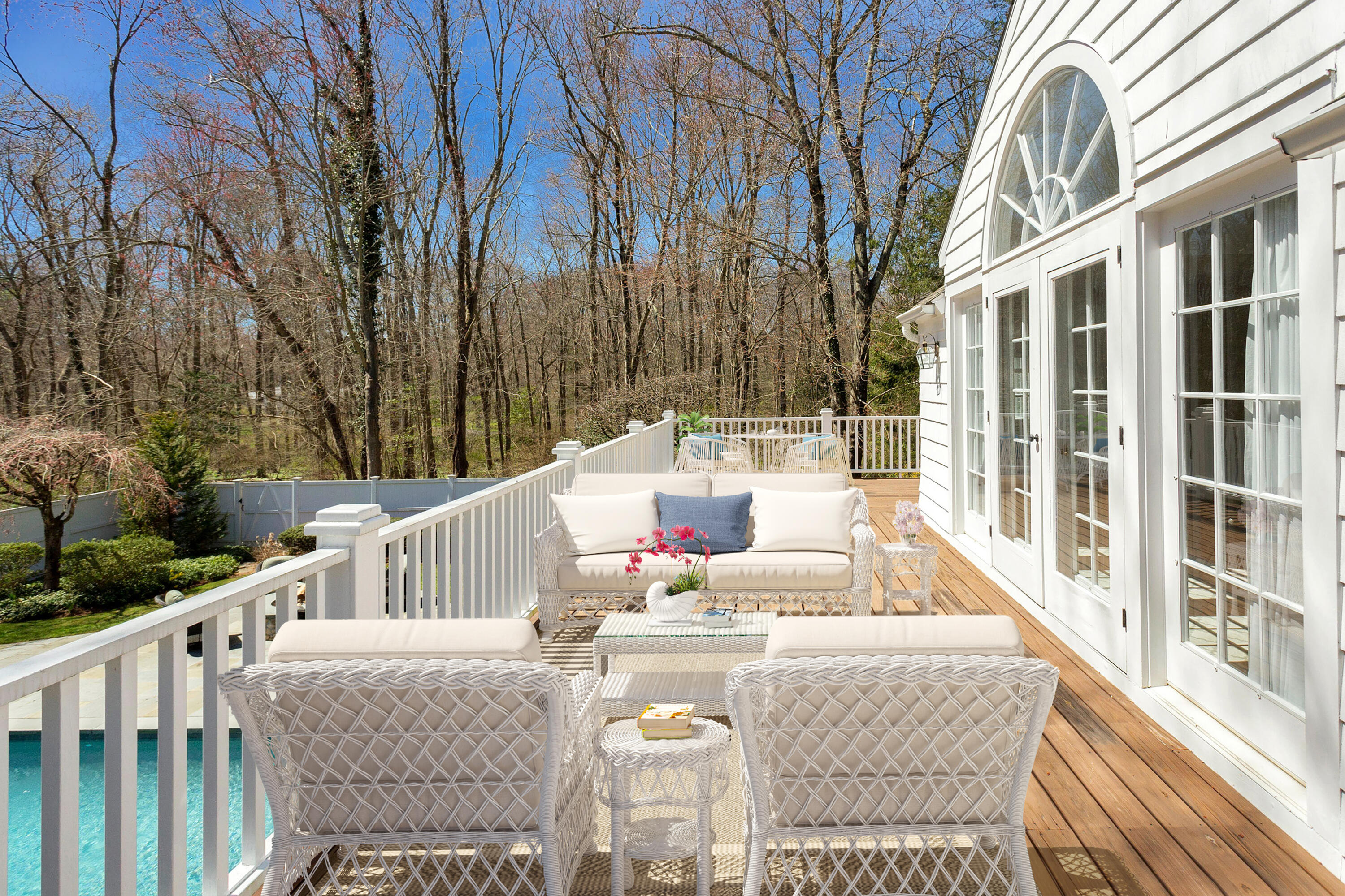 16 Half Mile Road Darien, CT 06820 - Photo 29 of 59 a view of a patio with couches table and chairs and wooden fence