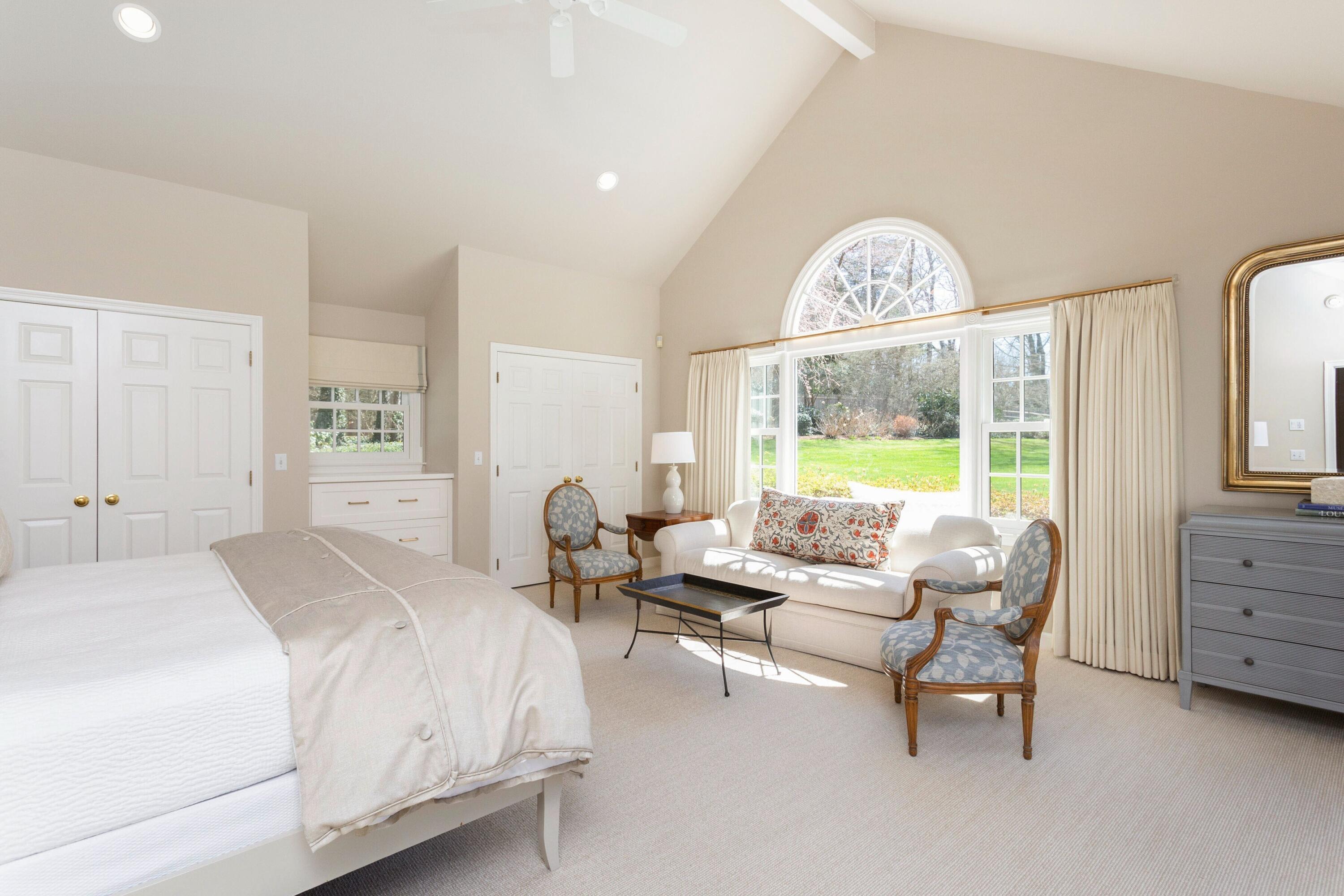 16 Half Mile Road Darien, CT 06820 - Photo 32 of 59 a spacious bedroom with a bed and glass window