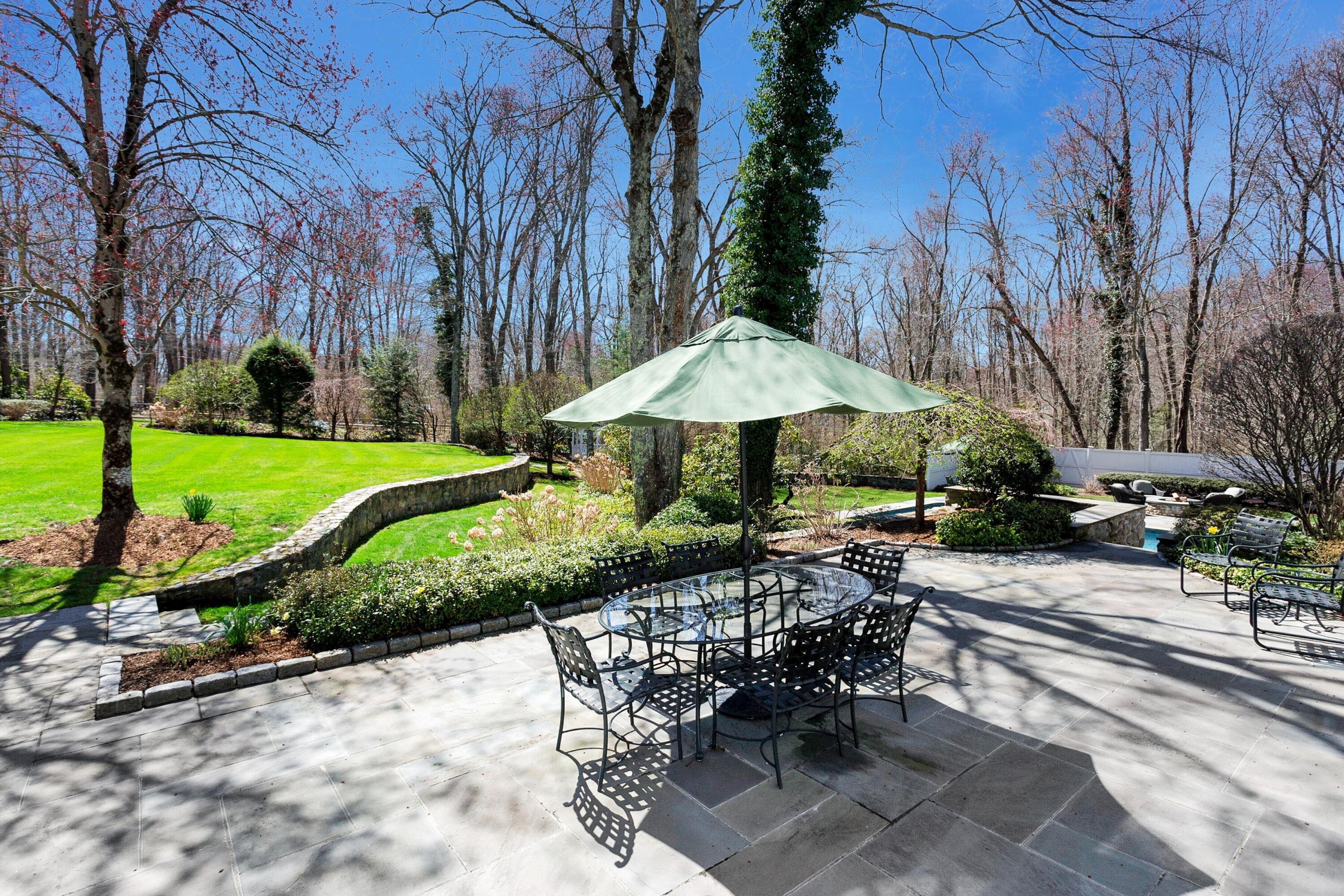 16 Half Mile Road Darien, CT 06820 - Photo 49 of 59 a view of a table and chairs under an umbrella