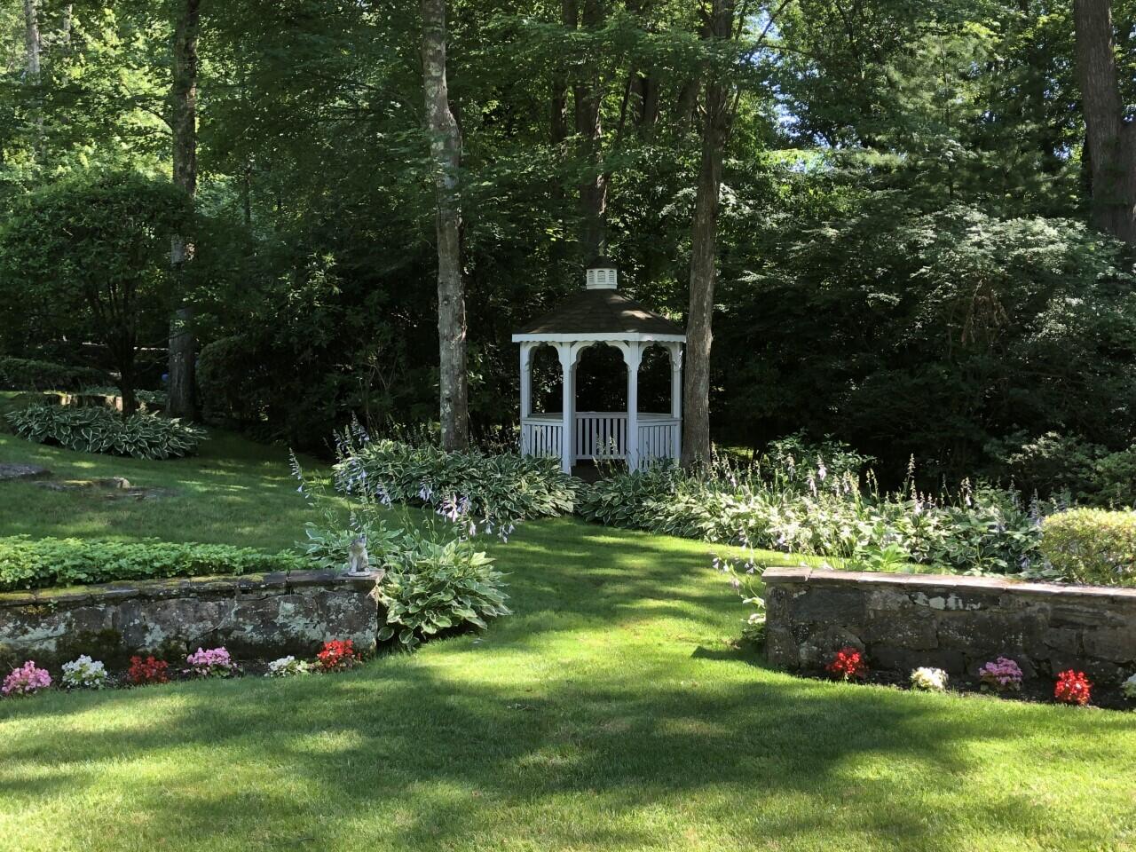 16 Half Mile Road Darien, CT 06820 - Photo 52 of 59 a front view of a house with a yard table and chairs