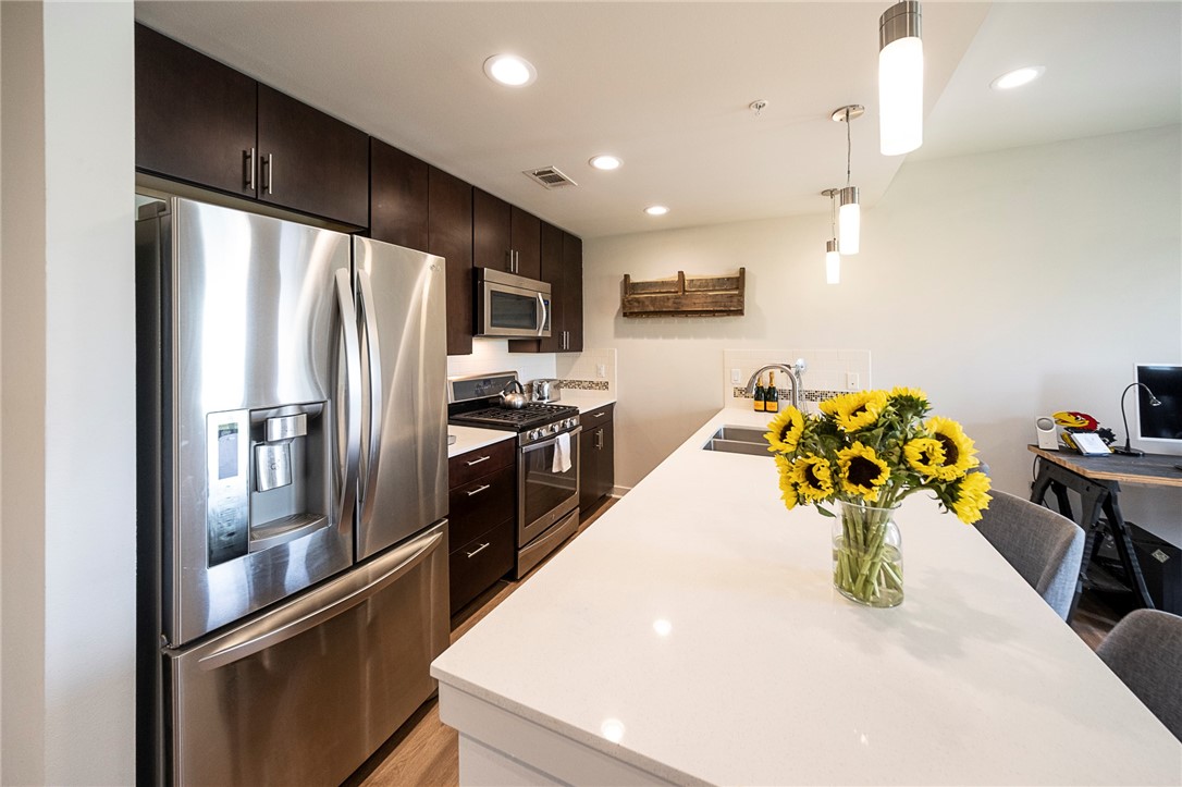 1603 Enfield Road, Unit 306 Austin, TX 78703 - Photo 2 of 16 Stainless Appliances, Recently replaced Dishwasher, Refrigerator with In Door Water/Ice, 5 Burner Gas Range. Silestone Counters and Island that seats 4 comfortably.