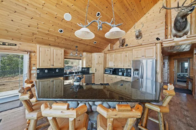 a kitchen with stainless steel appliances granite countertop a stove and cabinets