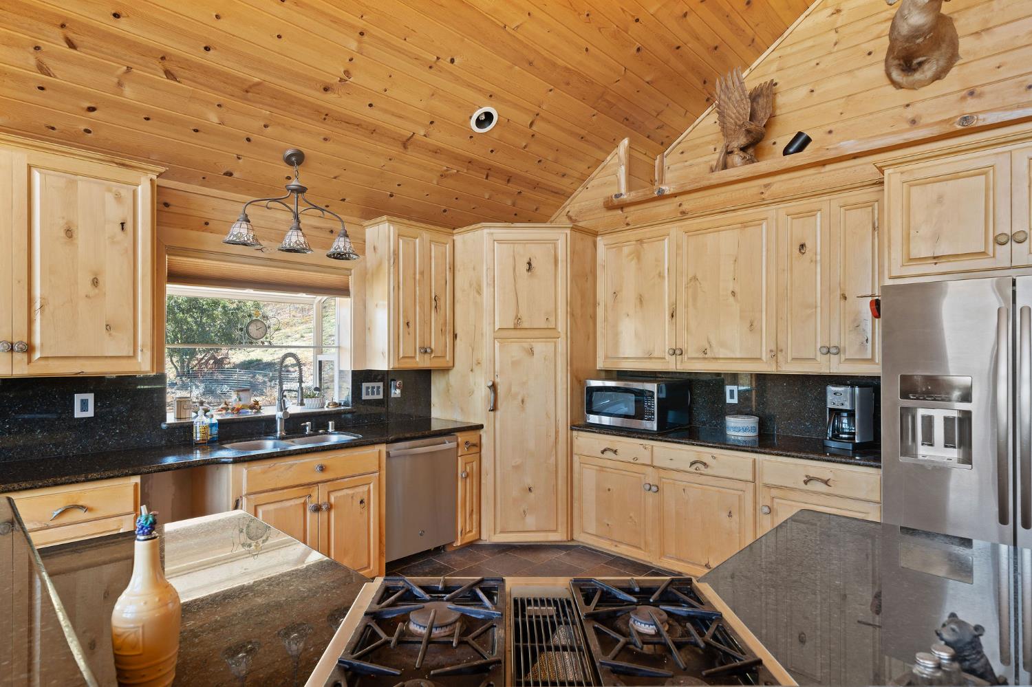 6800 West Murray Creek Road San Andreas, CA 95249 - Photo 13 of 47 a kitchen that has a lot of cabinets a sink and a stove