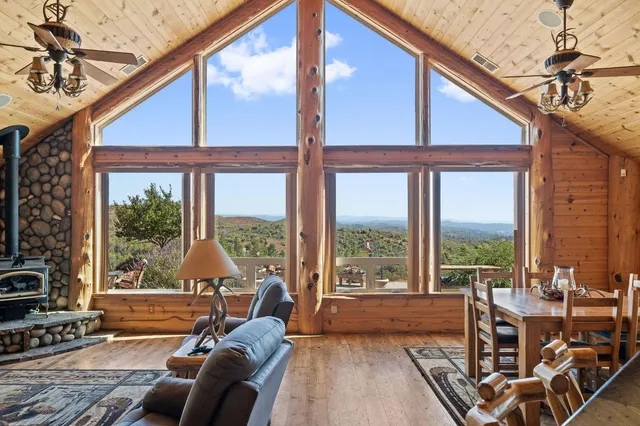 a living room with furniture and a floor to ceiling window