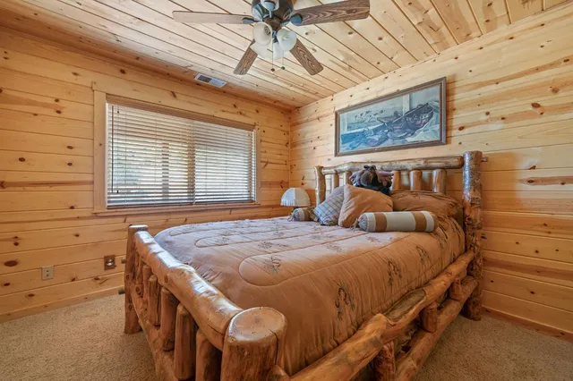 a bedroom with a bed and a table