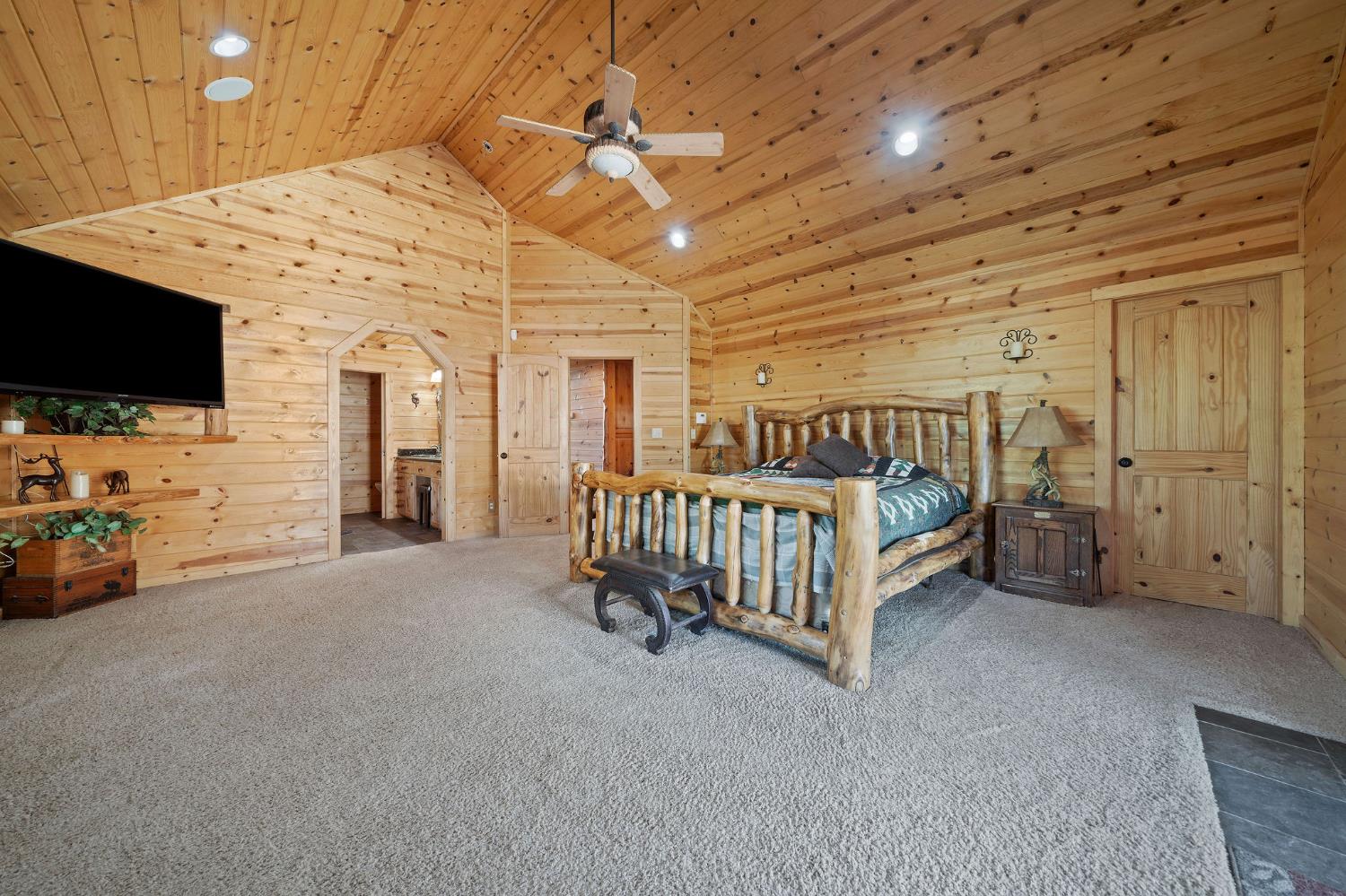6800 West Murray Creek Road San Andreas, CA 95249 - Photo 26 of 47 a spacious bedroom with a bed and a flat screen tv