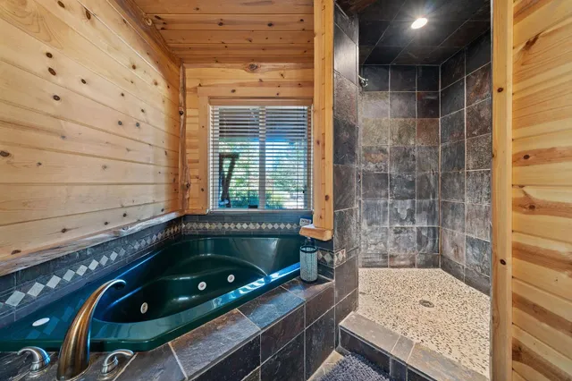 a bathroom with a tub and shower