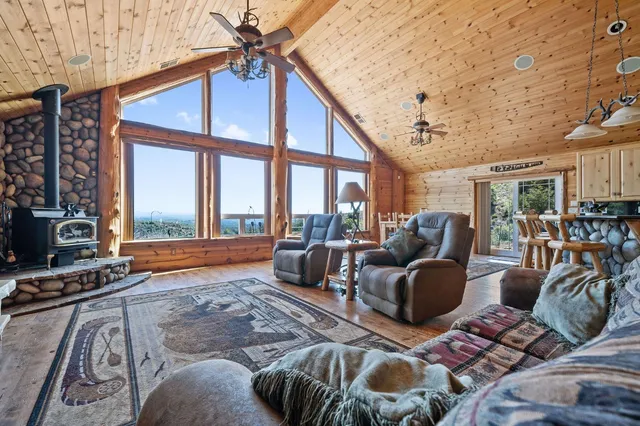 a living room with furniture and a floor to ceiling window