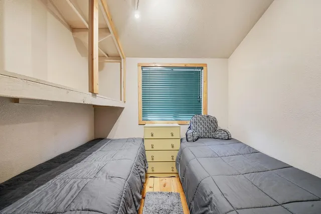 a bedroom with a bed and window