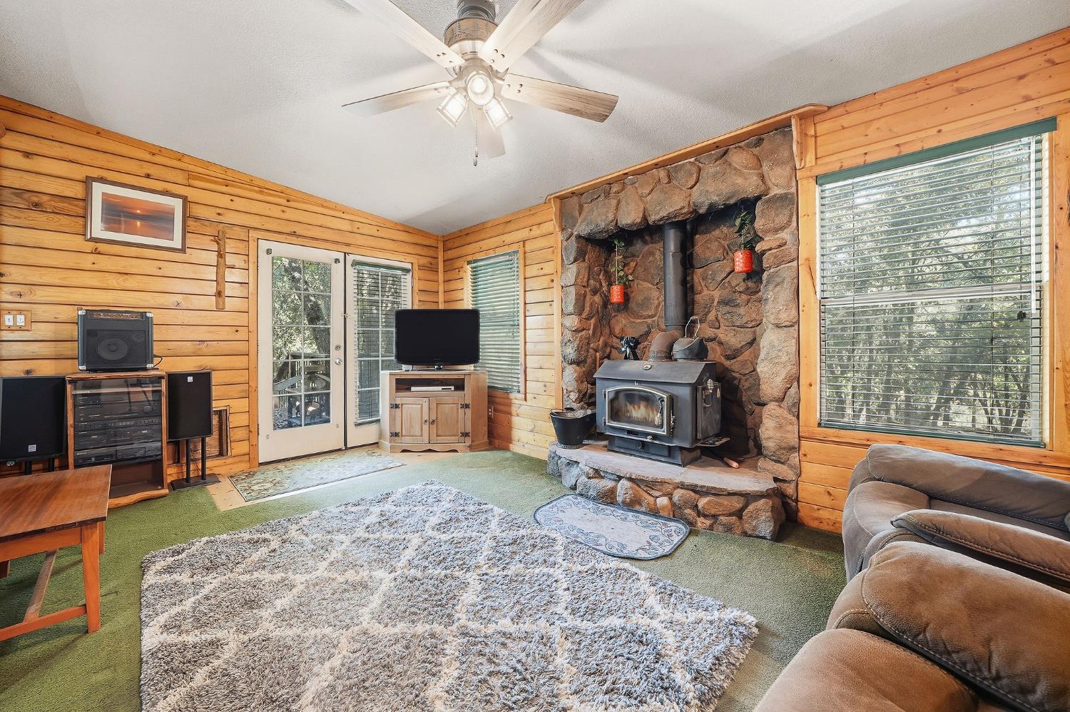 6800 West Murray Creek Road San Andreas, CA 95249 - Photo 36 of 47 a living room with furniture a flat screen tv and a large window