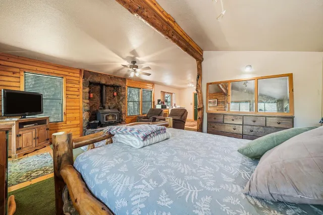 a spacious bedroom with a large bed and a flat screen tv