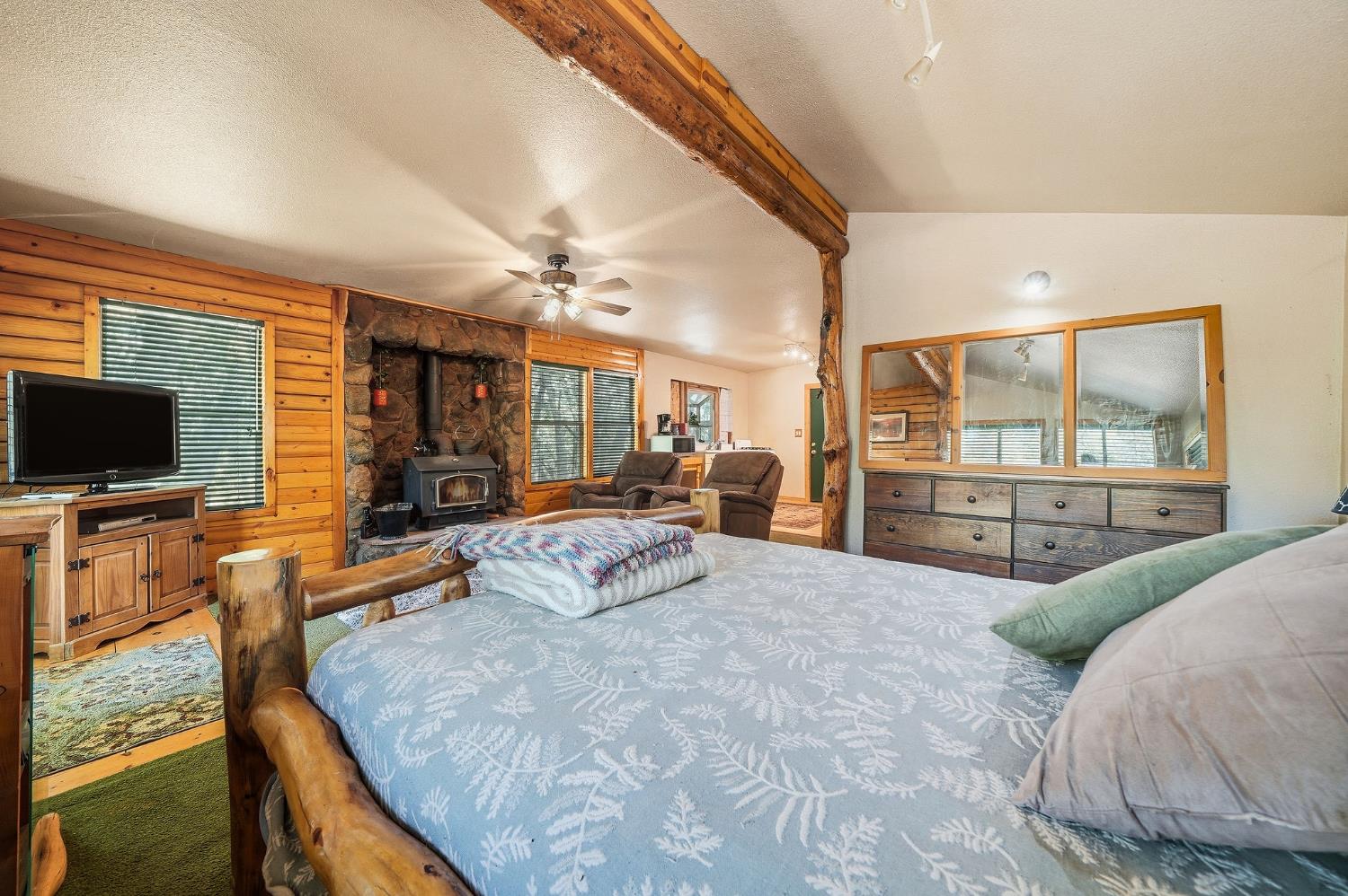 6800 West Murray Creek Road San Andreas, CA 95249 - Photo 37 of 47 a spacious bedroom with a large bed and a flat screen tv