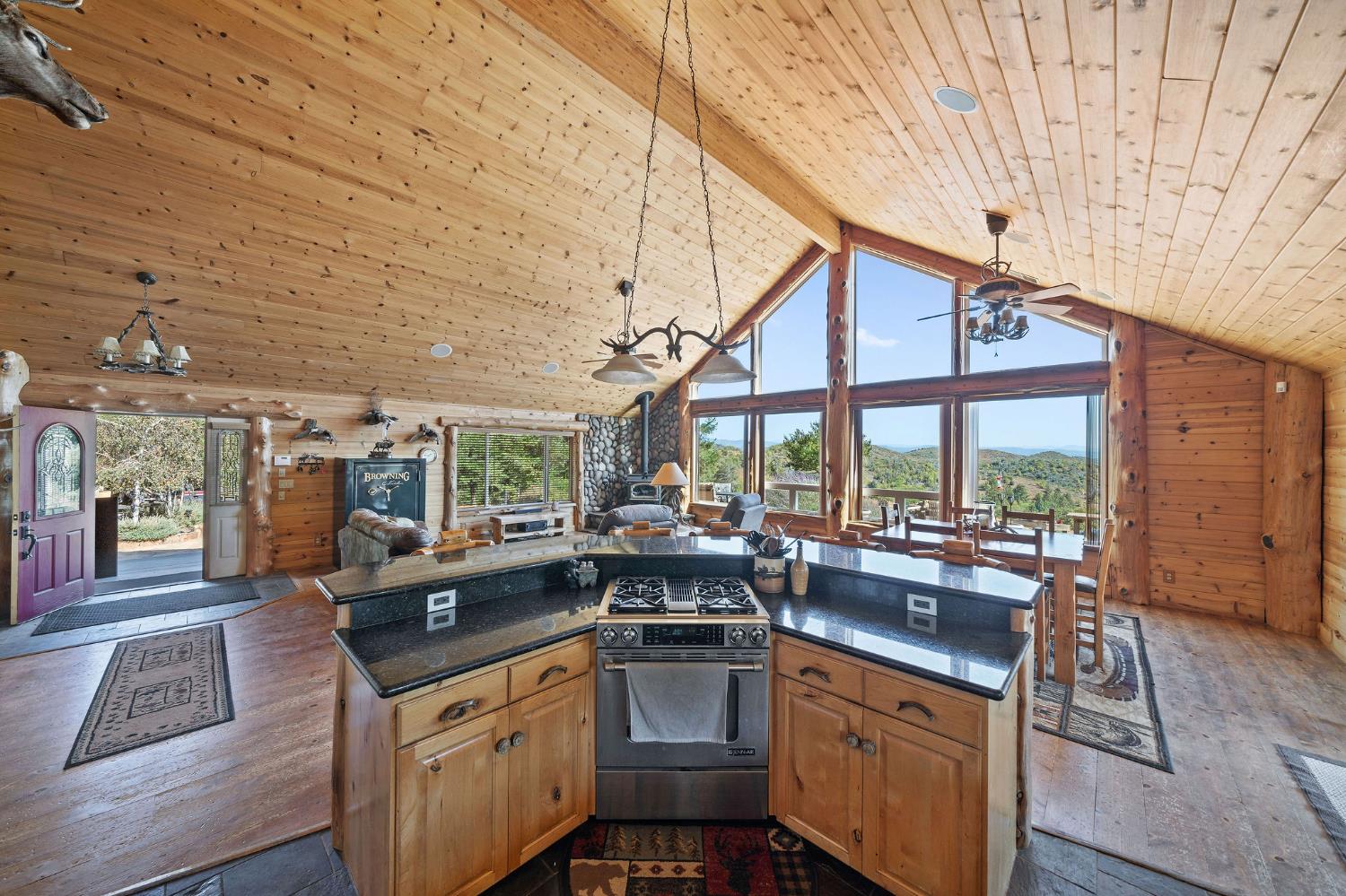 6800 West Murray Creek Road San Andreas, CA 95249 - Photo 10 of 47 a kitchen with stainless steel appliances granite countertop a sink and wooden cabinets