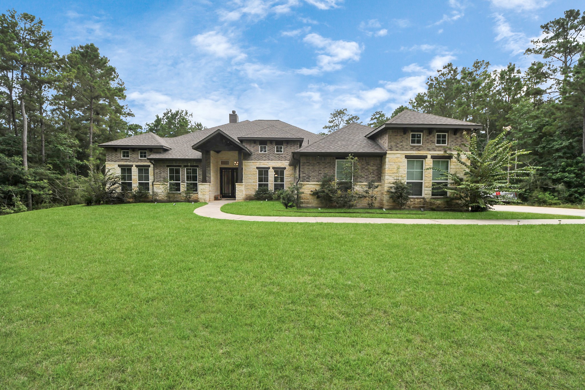 a front view of a house with a garden