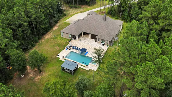 an aerial view of a house with swimming pool and outdoor space
