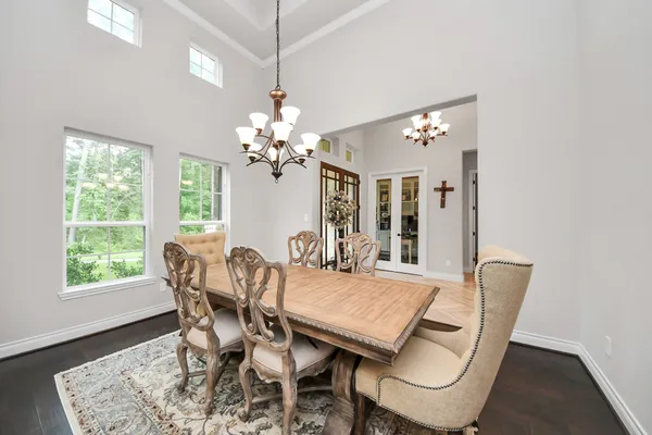 a dining room with furniture a rug and a chandelier