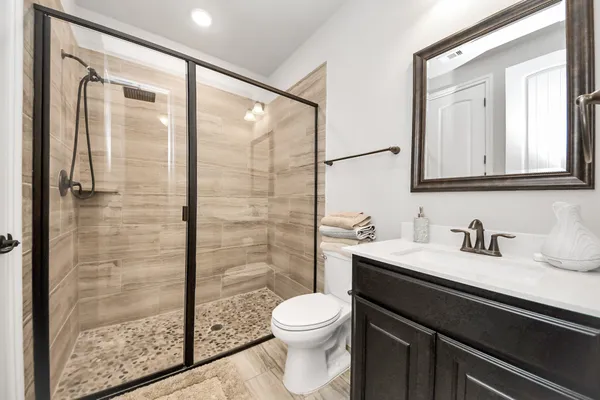 a bathroom with a toilet a sink and mirror