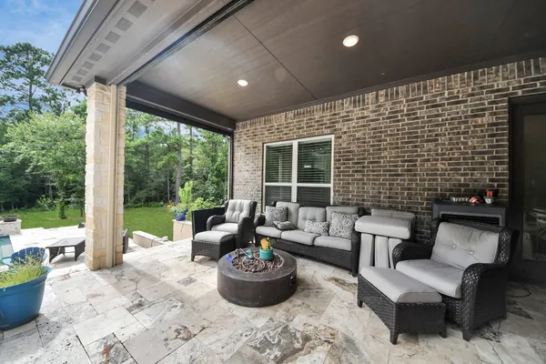 a view of a house with backyard porch and sitting area