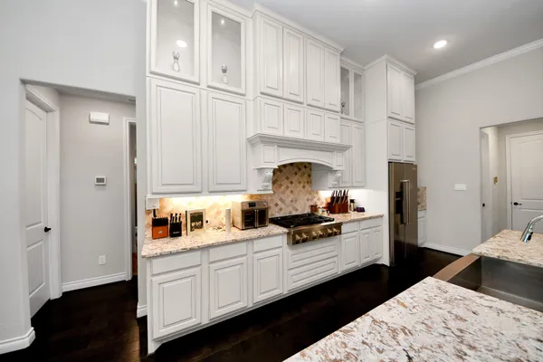 a kitchen with cabinets and a stove