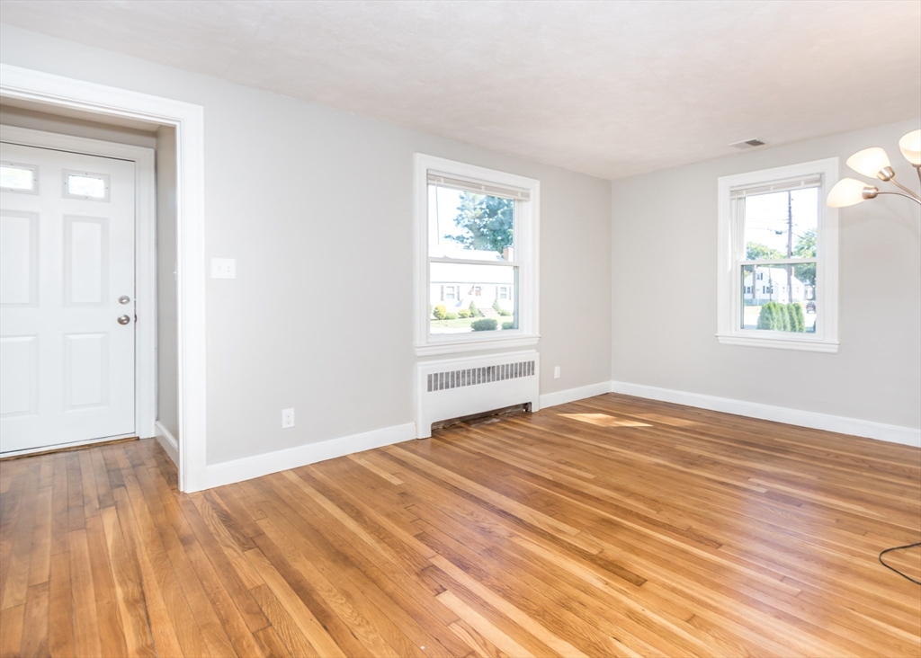 1166 Trapelo Road Waltham, MA 02451 - Photo 15 of 30 a view of an empty room with wooden floor and a window