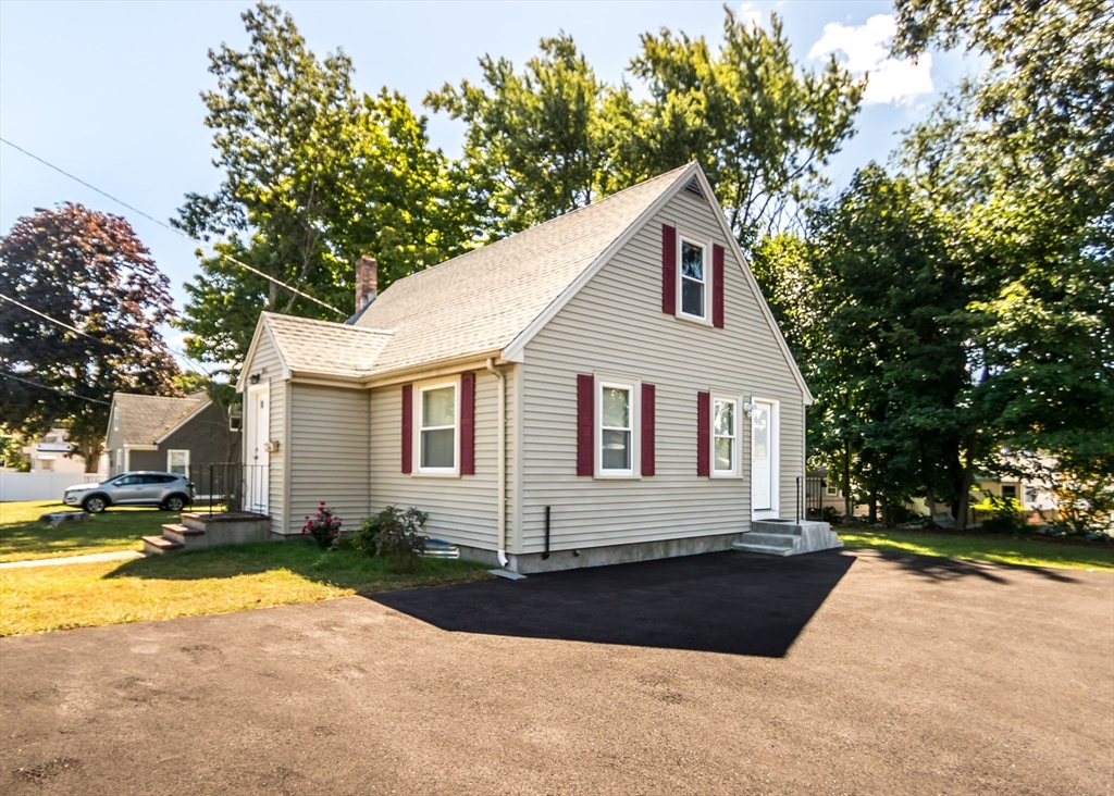 1166 Trapelo Road Waltham, MA 02451 - Photo 3 of 30 a front view of a house with a yard and garage