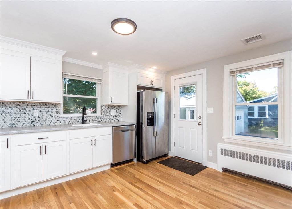 1166 Trapelo Road Waltham, MA 02451 - Photo 6 of 30 a kitchen with stainless steel appliances granite countertop a stove a sink and a refrigerator
