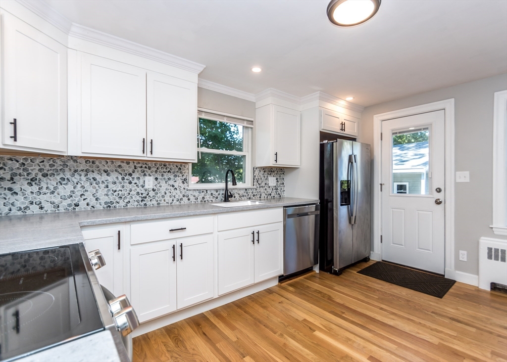 1166 Trapelo Road Waltham, MA 02451 - Photo 9 of 30 a kitchen with stainless steel appliances granite countertop a refrigerator sink and cabinets