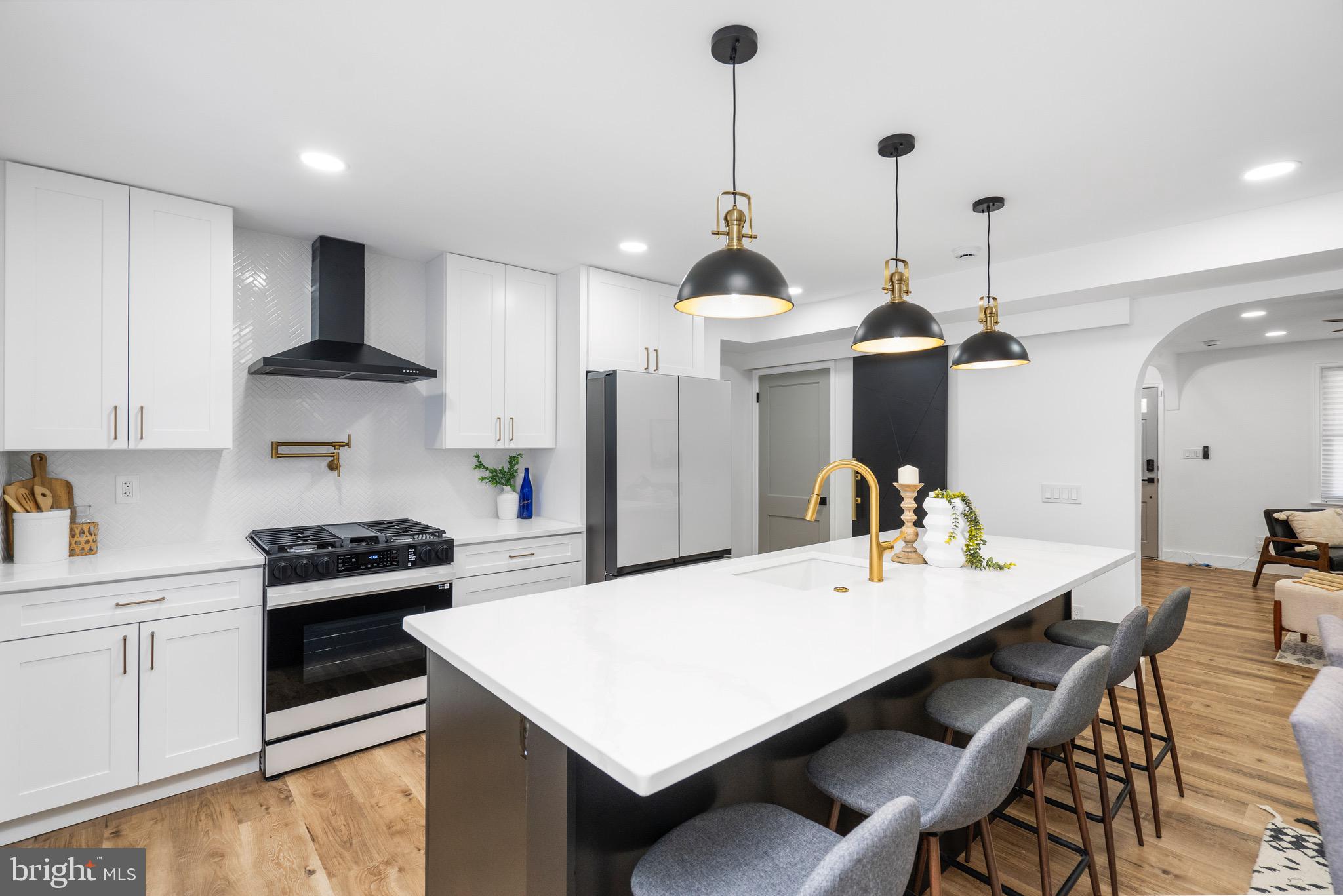 1808 Winford Road Baltimore, MD 21239 - Photo 13 of 39 a kitchen with a sink a stove and chairs