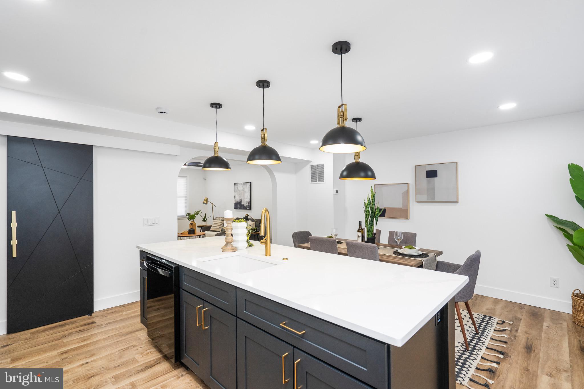 1808 Winford Road Baltimore, MD 21239 - Photo 14 of 39 a kitchen with kitchen island white cabinets and sink