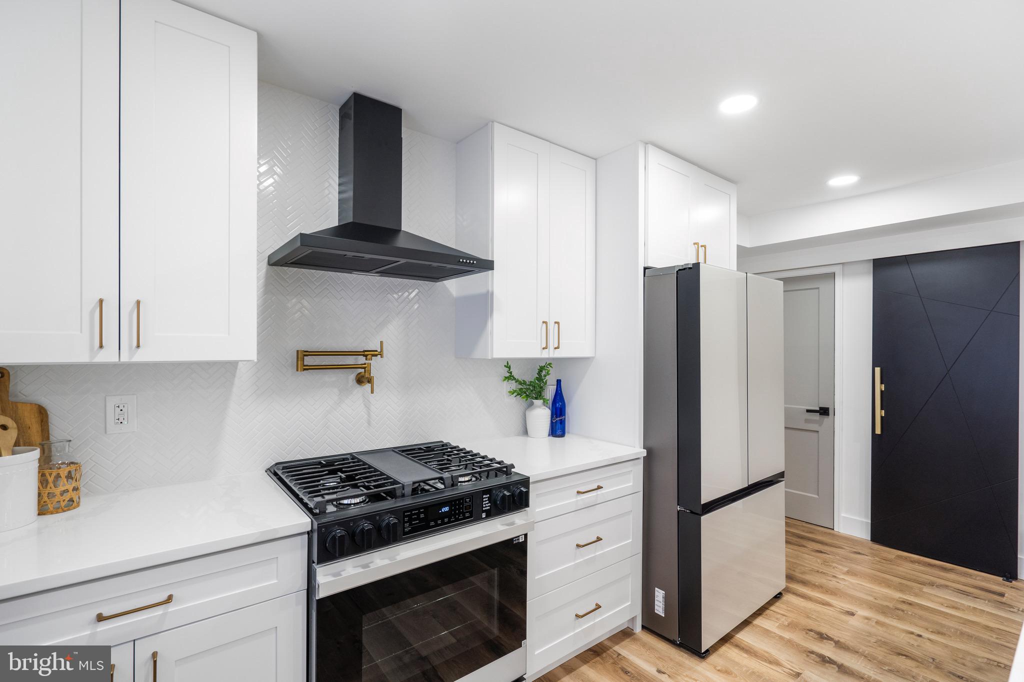 1808 Winford Road Baltimore, MD 21239 - Photo 17 of 39 a kitchen with stainless steel appliances granite countertop a refrigerator and a stove top oven