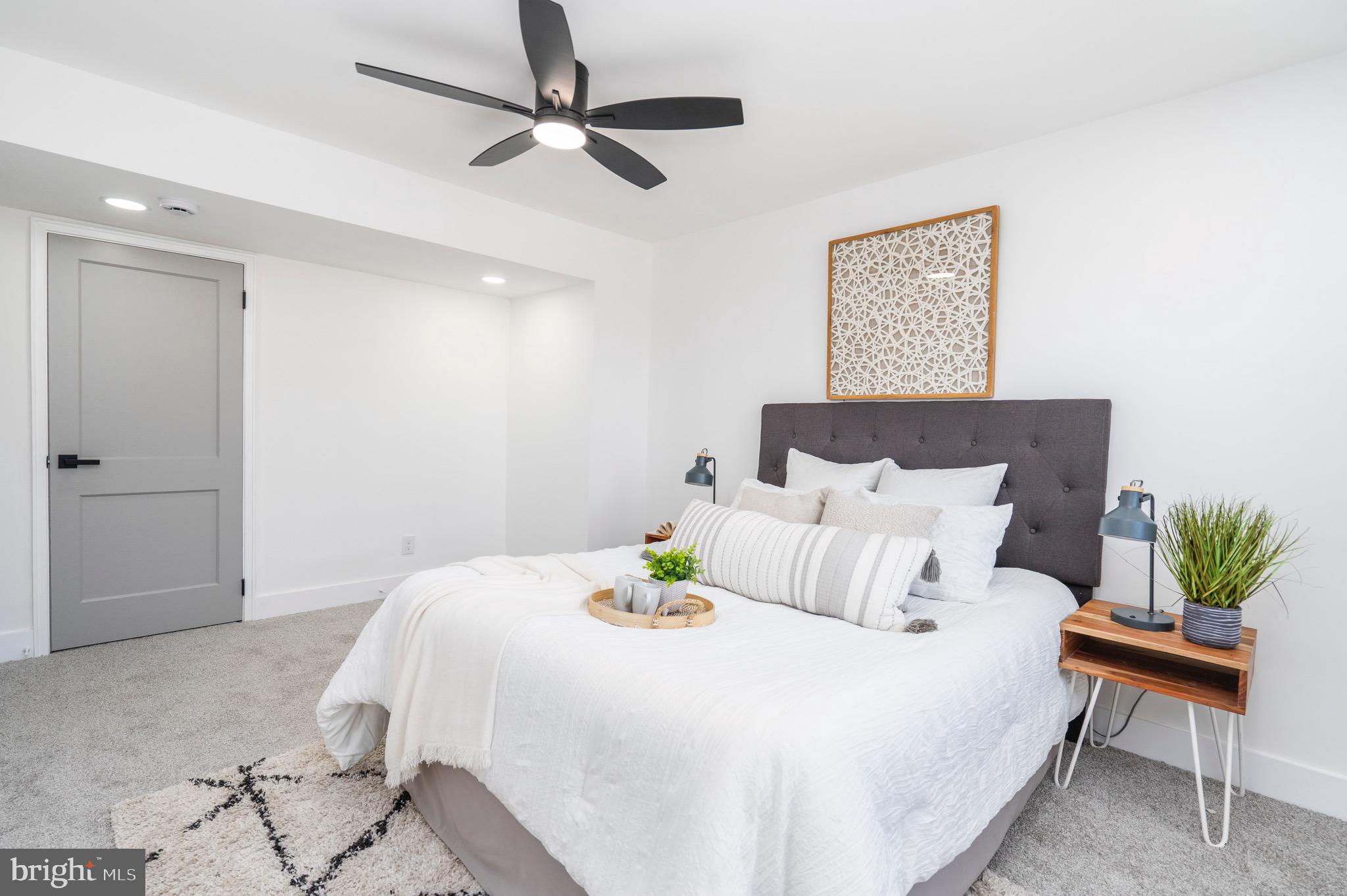 1808 Winford Road Baltimore, MD 21239 - Photo 21 of 39 a bedroom with a bed and a chandelier