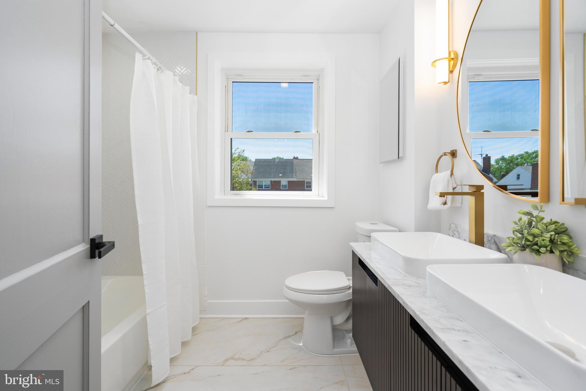 1808 Winford Road Baltimore, MD 21239 - Photo 26 of 39 a bathroom with a sink a toilet and a mirror