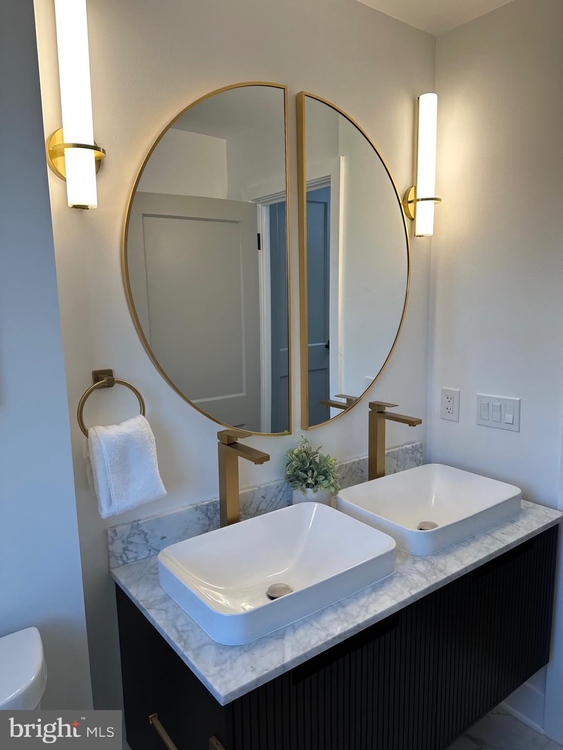 1808 Winford Road Baltimore, MD 21239 - Photo 27 of 39 a bathroom with a granite countertop sink a mirror and a toilet