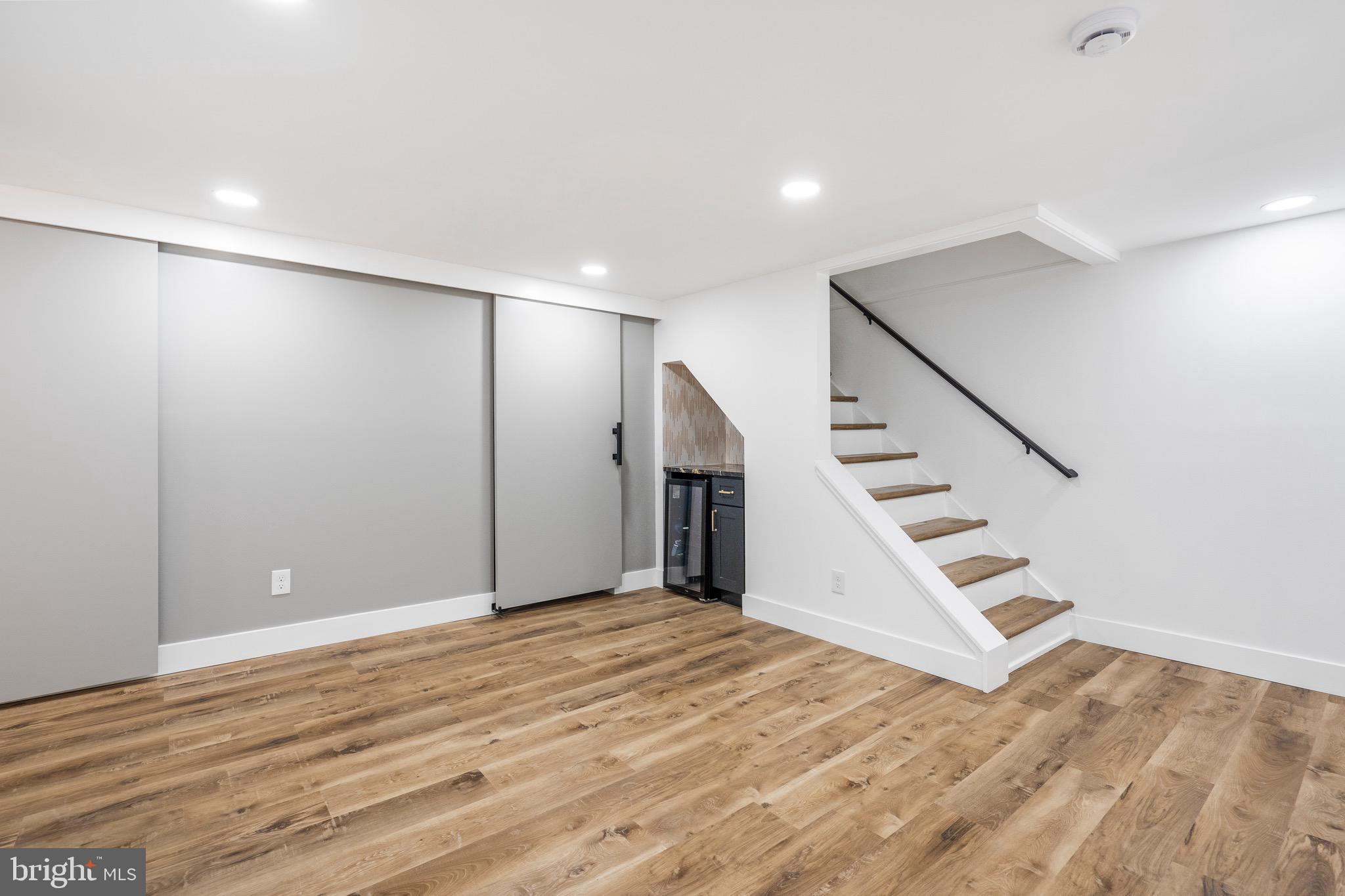 1808 Winford Road Baltimore, MD 21239 - Photo 31 of 39 a view of an empty room with wooden floor and stairs
