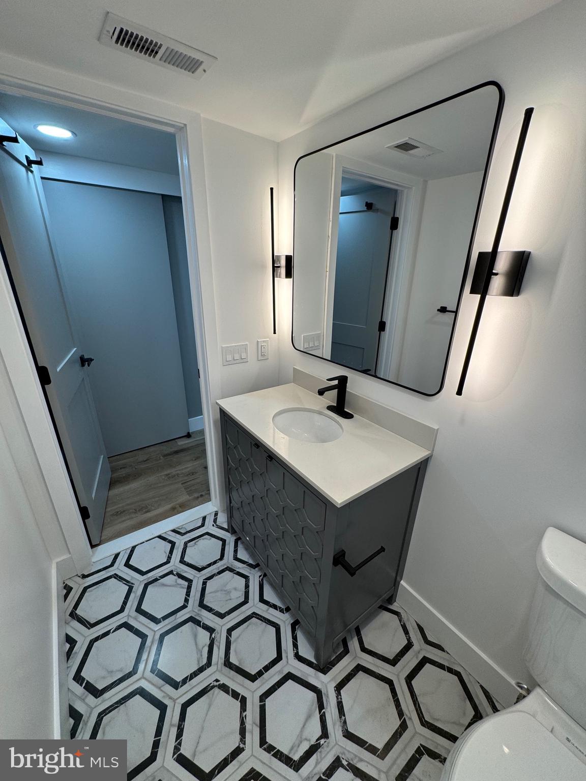 1808 Winford Road Baltimore, MD 21239 - Photo 34 of 39 a bathroom with a sink toilet and shower