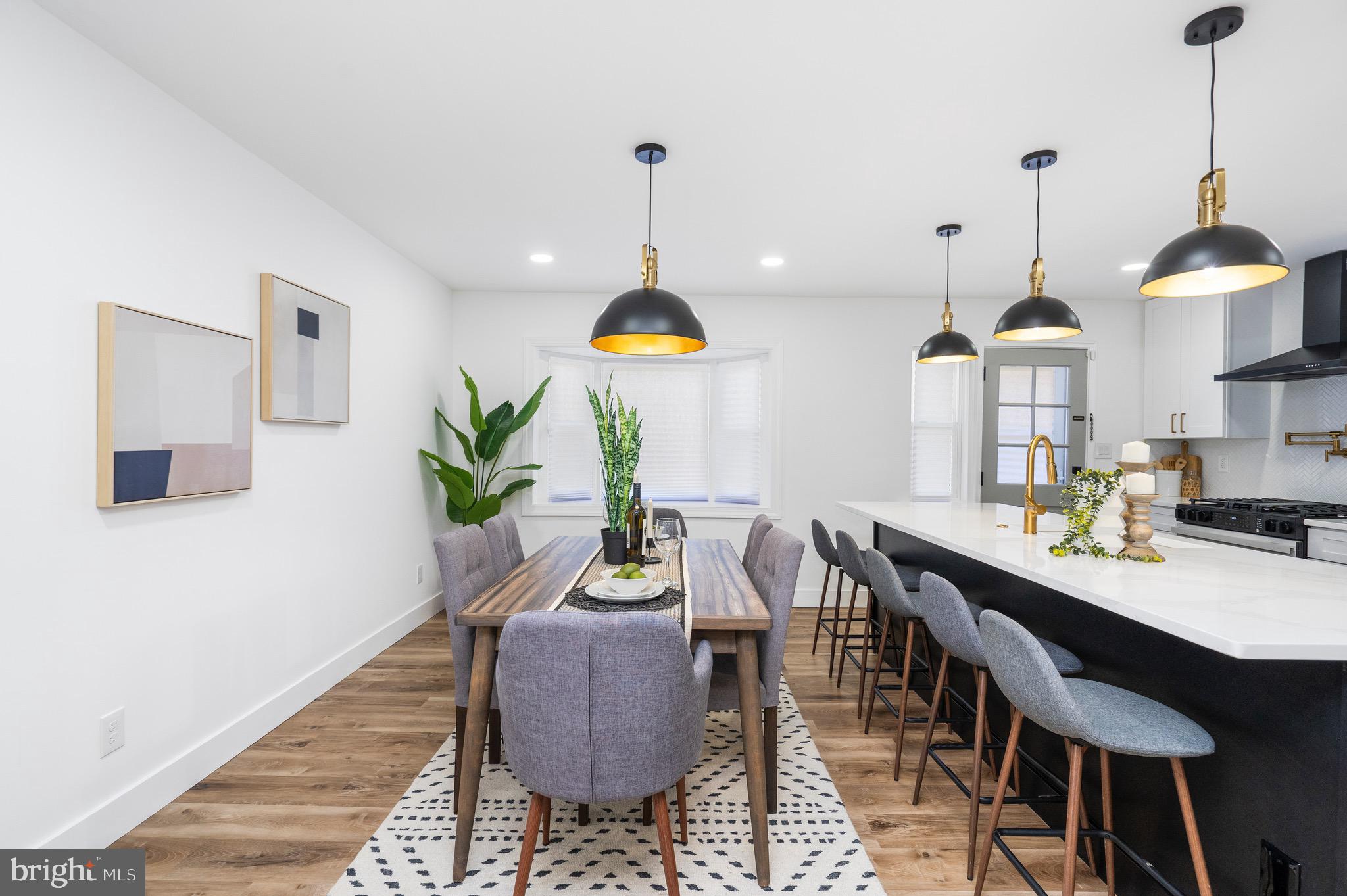 1808 Winford Road Baltimore, MD 21239 - Photo 10 of 39 a dining room with furniture potted plants and wooden floor