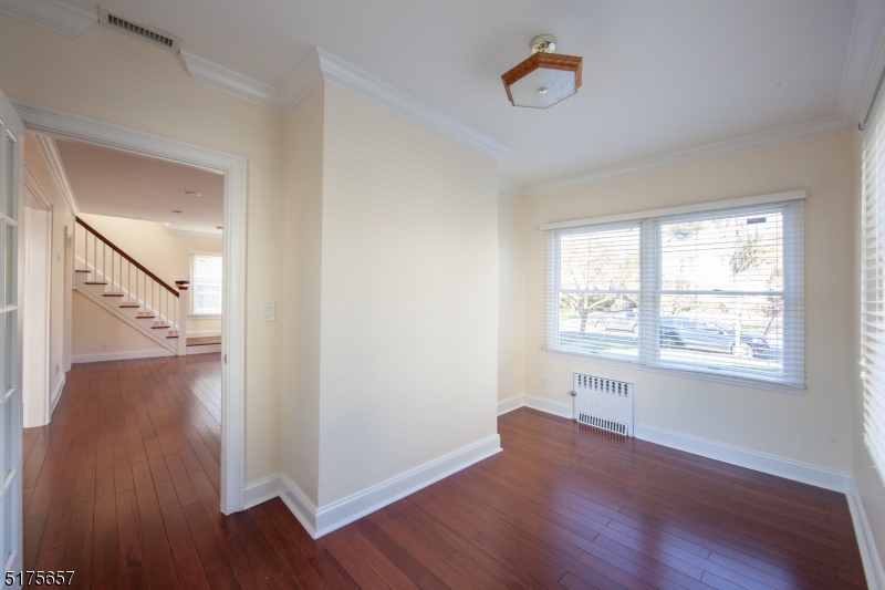 16 Columbus Avenue Glen Ridge, NJ 07028 - Photo 4 of 14 an empty room with wooden floor and a window