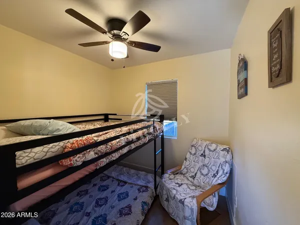 a living room with couch and a ceiling fan