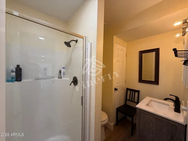 a bathroom with a sink toilet and shower