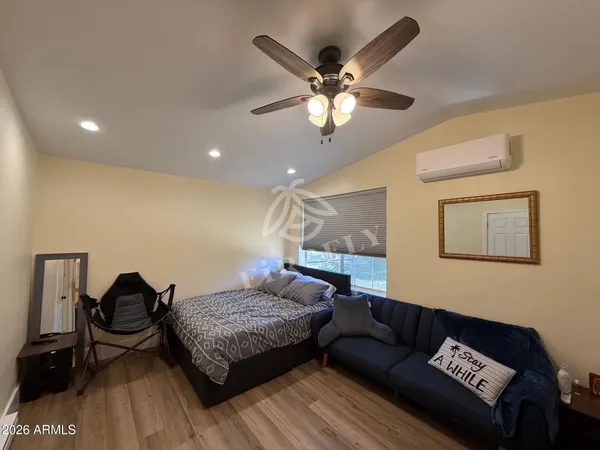 a living room with furniture and a ceiling fan