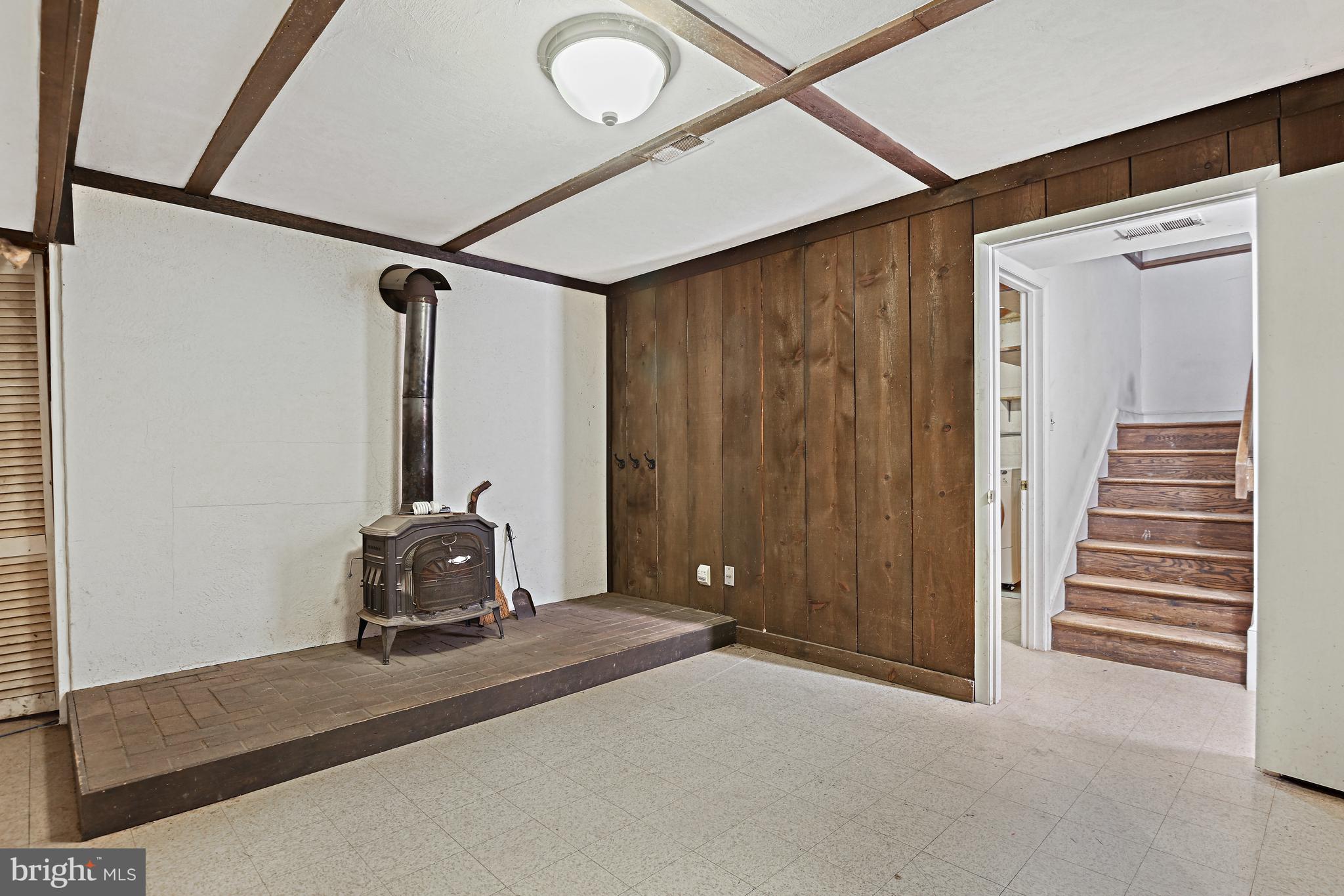 12008 Whip Road Reston, VA 20191 - Photo 35 of 48 The lower-level recreation room has a wood stove.