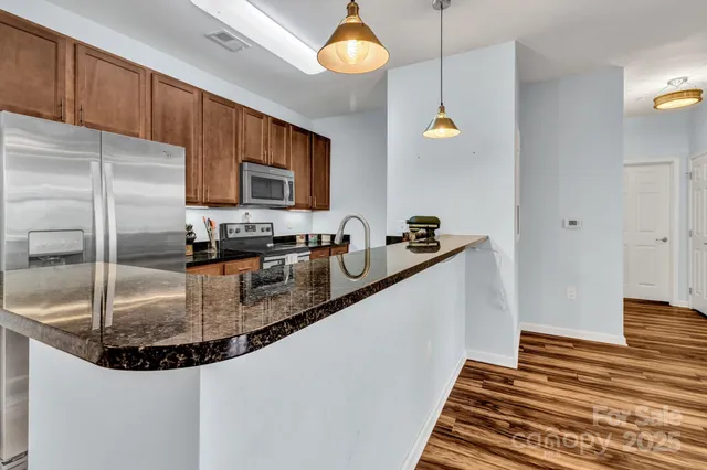 a kitchen with counter top space cabinets and stainless steel appliances